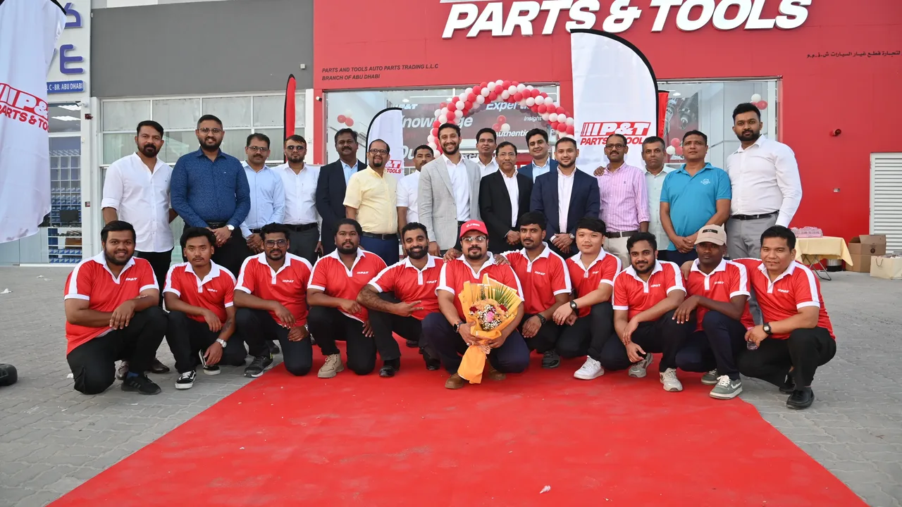 The Parts & Tools team in red uniforms in front of the Abu Dhabi showroom